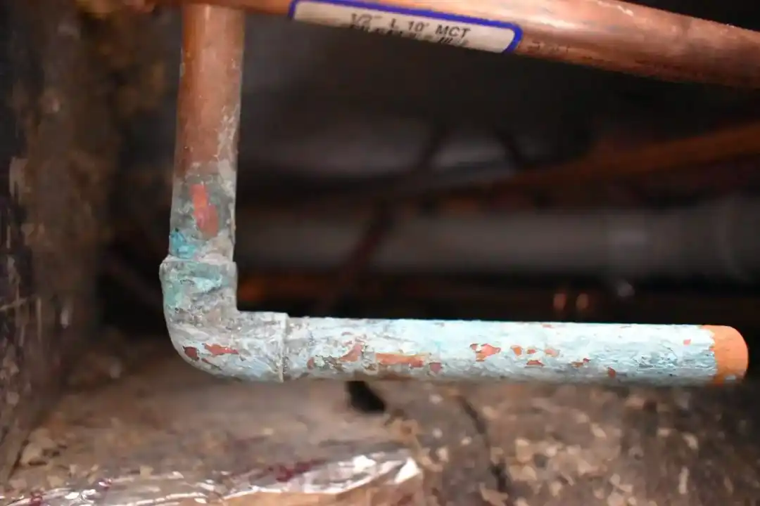 Corroded copper water lines with visible oxidation before repair or replacement