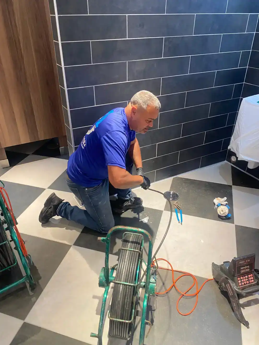 Plumber using a sewer camera to inspect a residential drain line