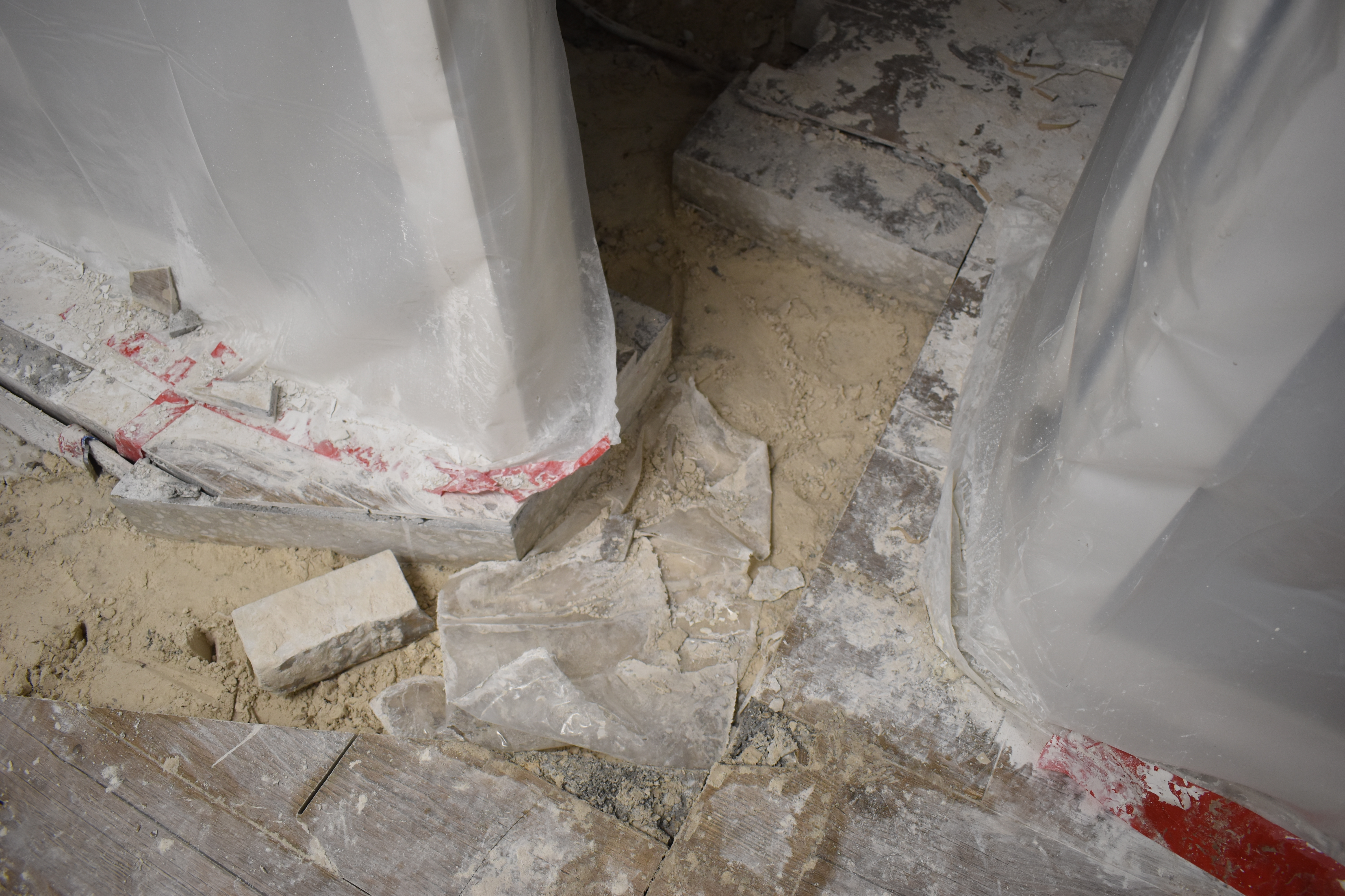 Cast iron pipe replacement in progress showing new PVC installation