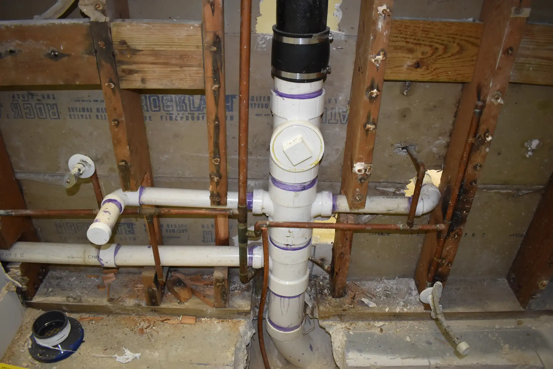 Completed cast iron replacement with new PVC pipes behind wall